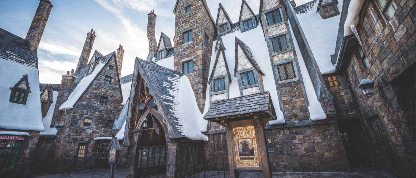 Snow covered entrance to the Three Broomsticks restaurant in The Wizarding World of Harry Potter Hogsmeade at Universal Islands of Adventure.