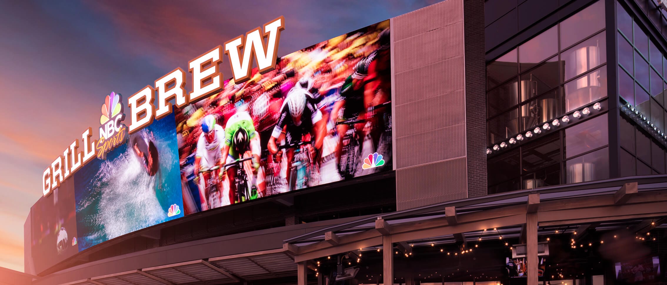 A sunset photo captures the exterior of the NBC Sports Grill & Brew at Universal CityWalk Orlando.