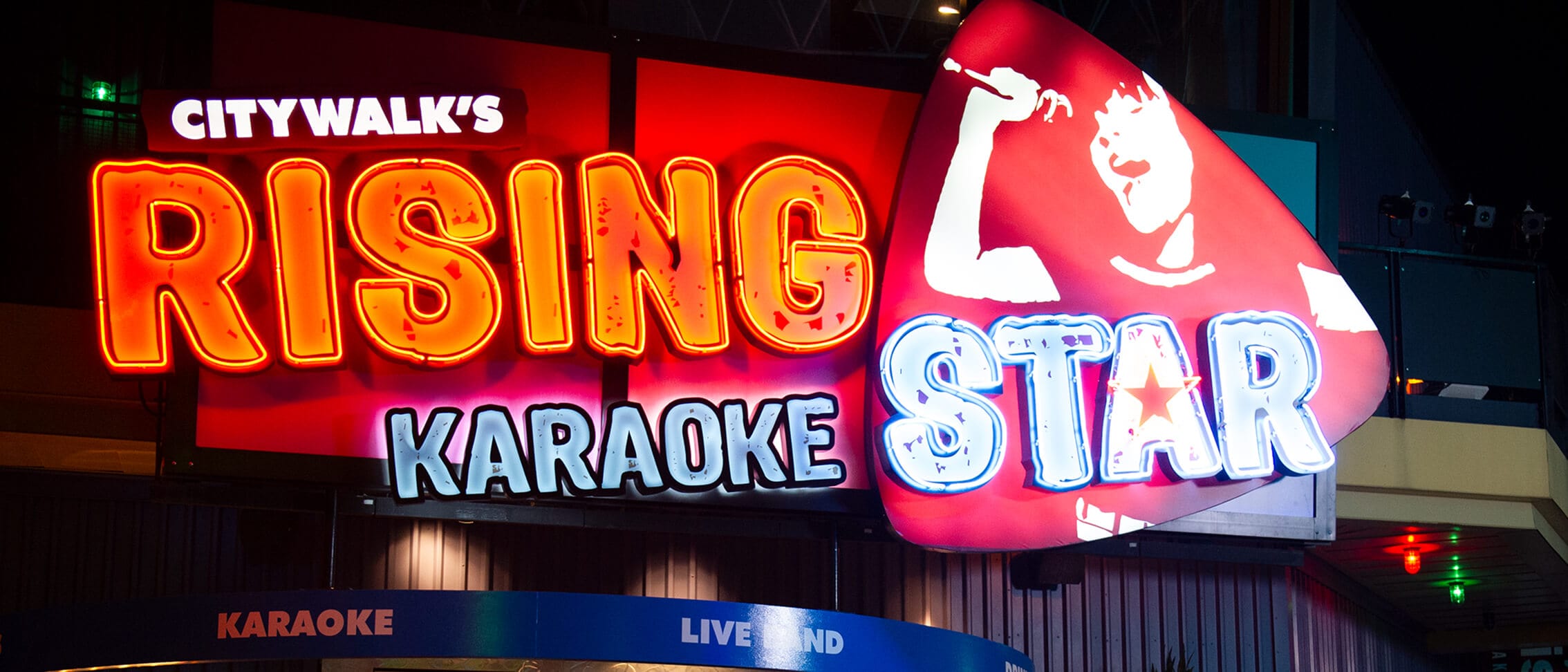 A nighttime exterior view of CityWalk’s Rising Star karaoke bar at Universal CityWalk Orlando.