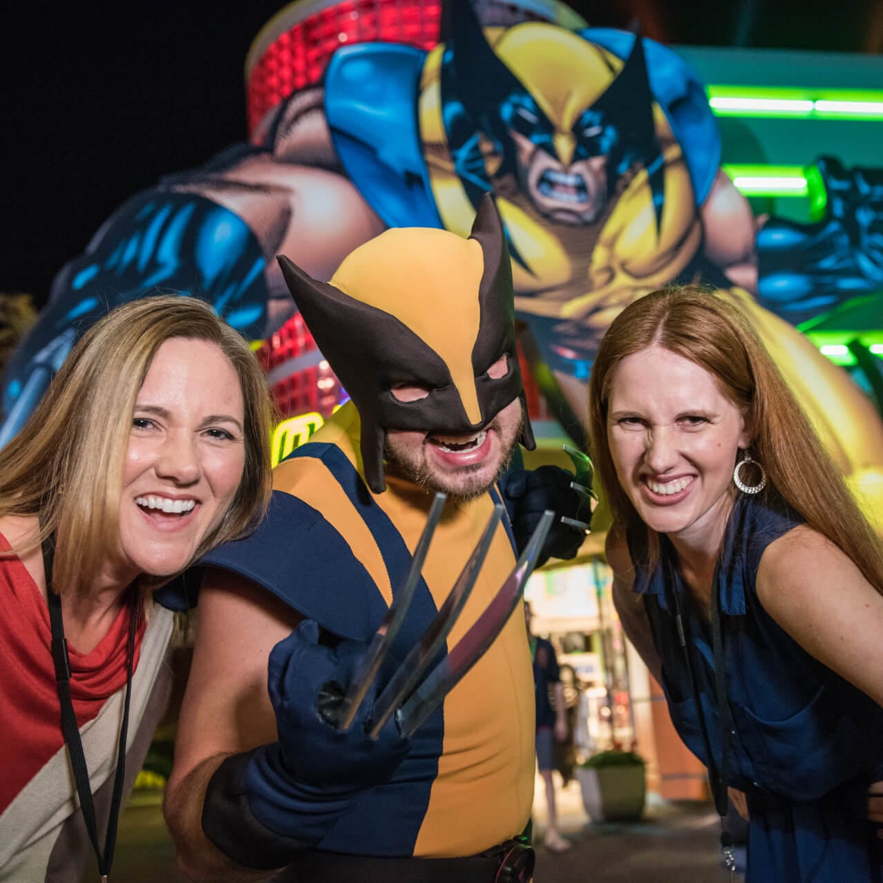 Smiling guests posing with Wolverine at Marvel Super Hero Island