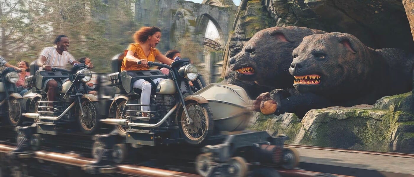 Screaming riders on Hagrid's Magical Creatures Motorbike Adventure approach Fluffy, Hagrid’s three-headed dog.