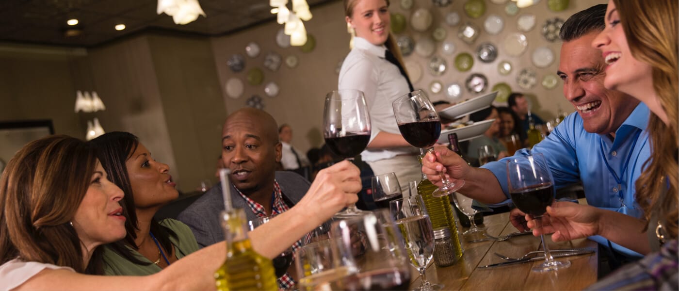 A group of friends sharing a toast over dinner