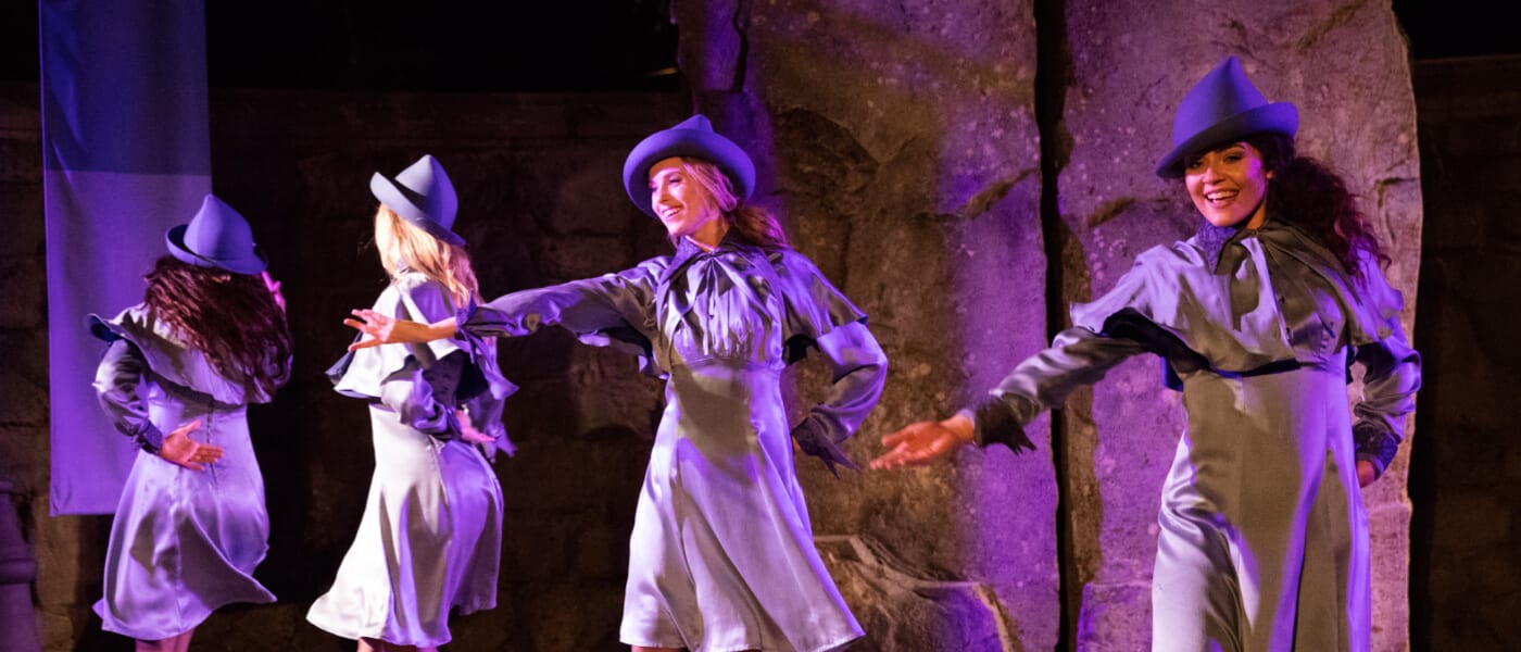 Students from the all girls Beauxbatons wizard school performing in the Triwizard Spirit Rally live show in The Wizarding World of Harry Potter Hogsmeade at Universal Islands of Adventure.