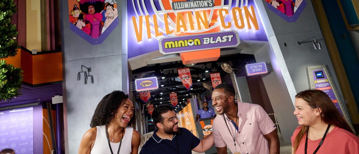 Four laughing guests in front of Minion Blast
