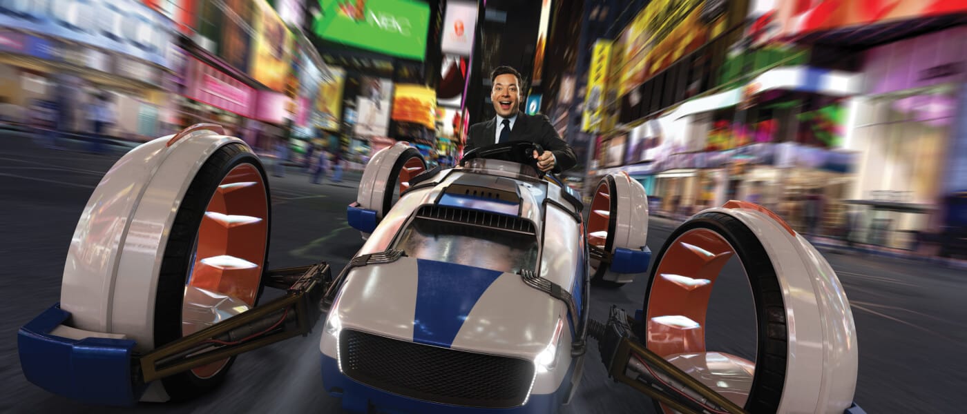 Jimmy Fallon in a futuristic car racing down a street in New York