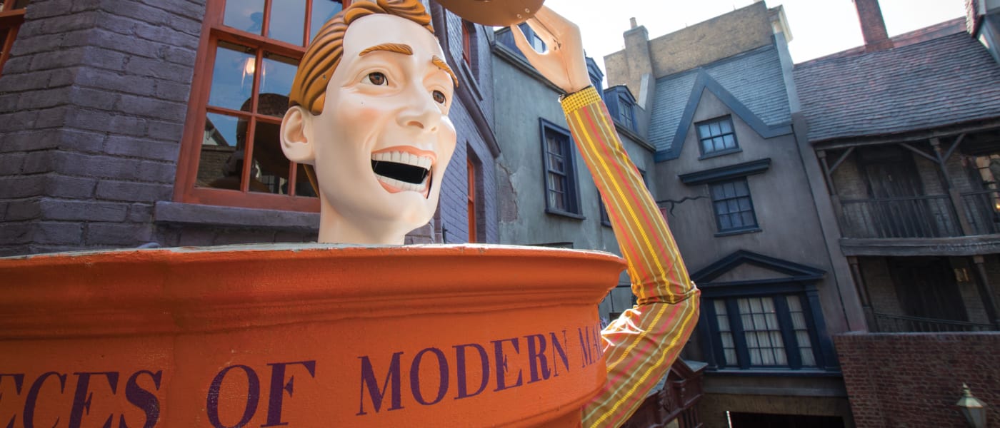 statue of a man smiling tipping his had