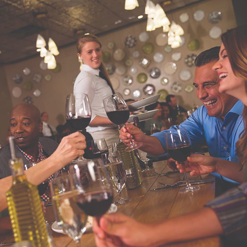 Diners toasting with glasses of wine.