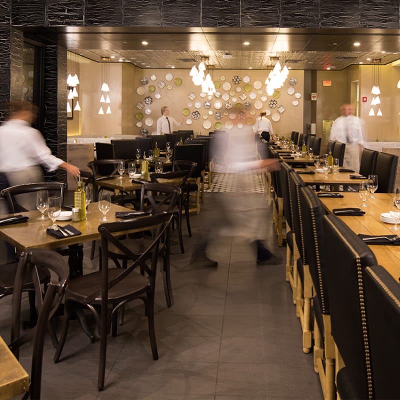 Staff preparing restaurant tables for an event.