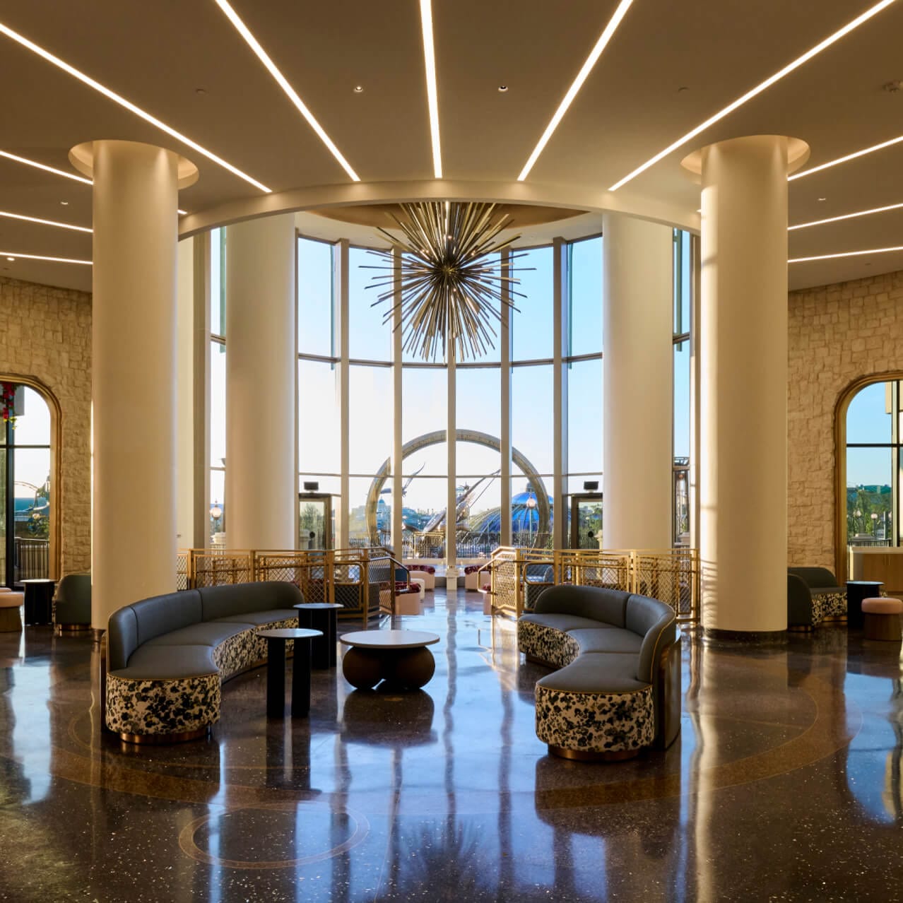 Universal Helios Grand Hotel, a Loews Hotel, lobby and lounge area, with spacious seating and floor-to-ceiling views of Universal Epic Universe.