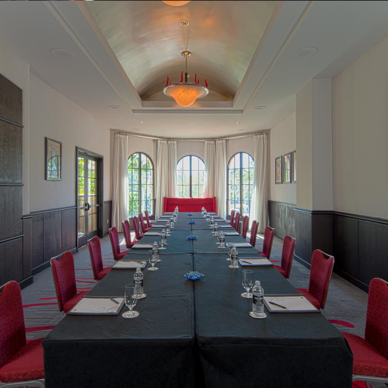 The Apollo Boardroom meeting space setup with tables, chairs, and meeting materials.
