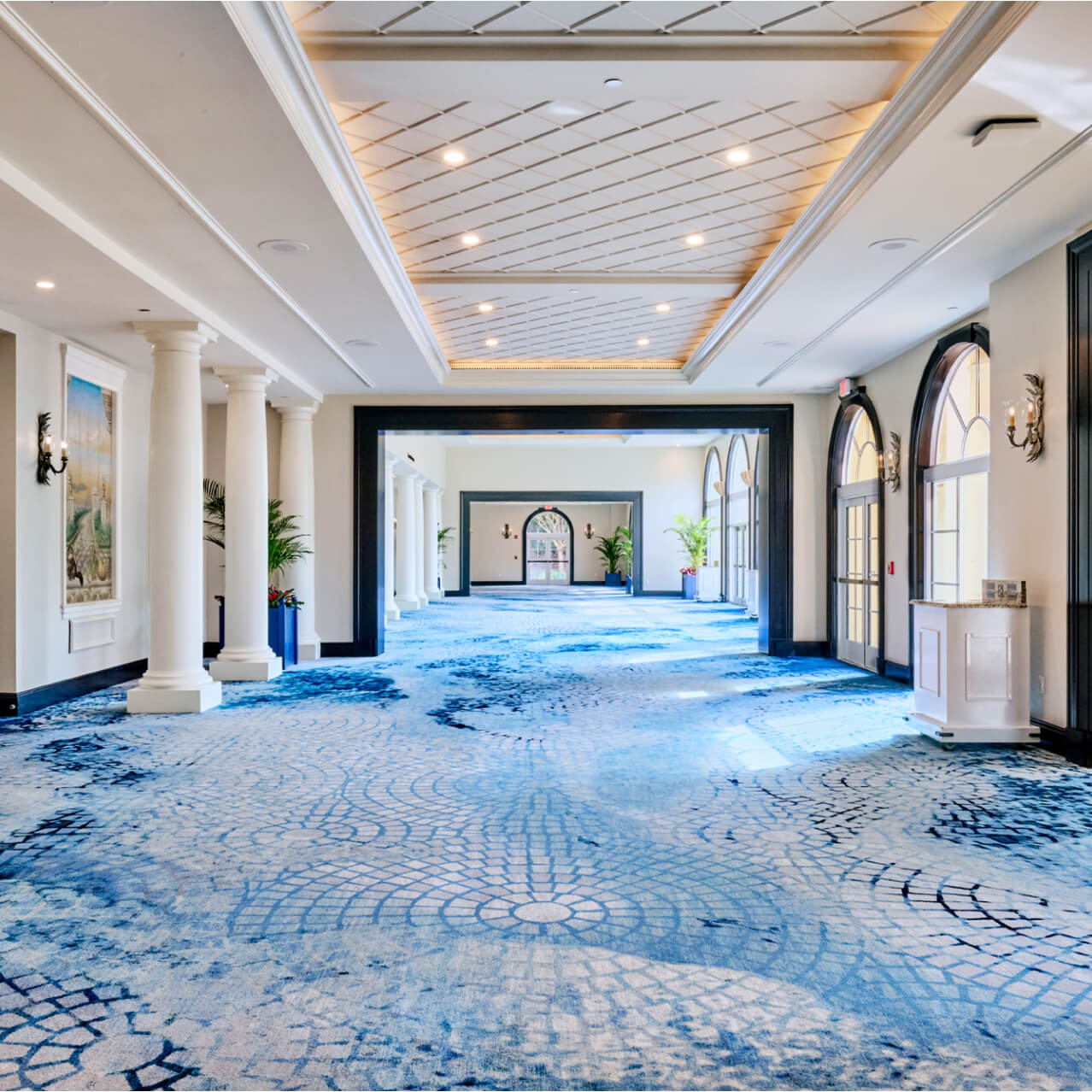A hallway leading to meeting spaces inside of Loews Portofino Bay Hotel.