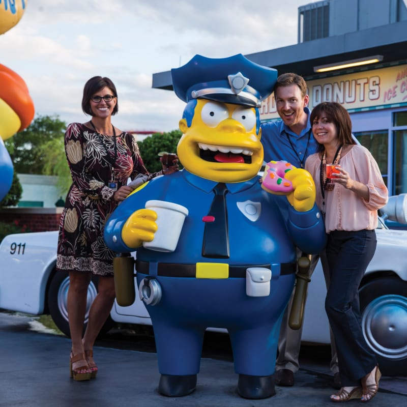 Attendees taking a picture with Chief Wiggins in the Krustyland attraction at Universal Studios Florida