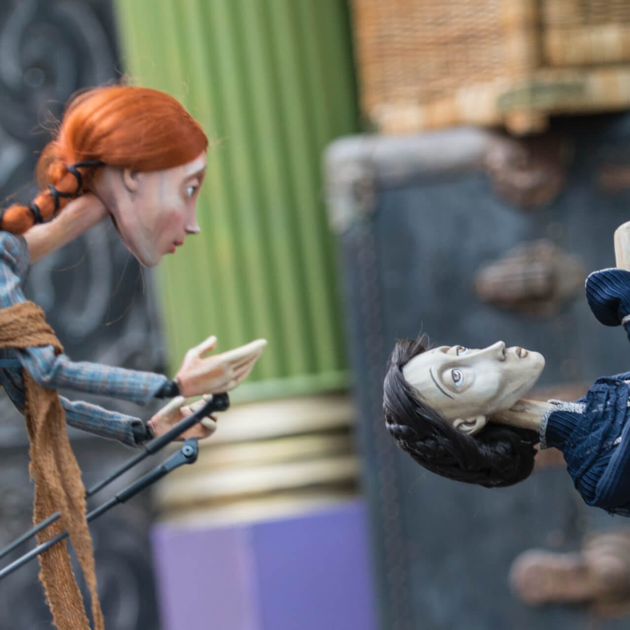 woman puppet looks at a male puppet