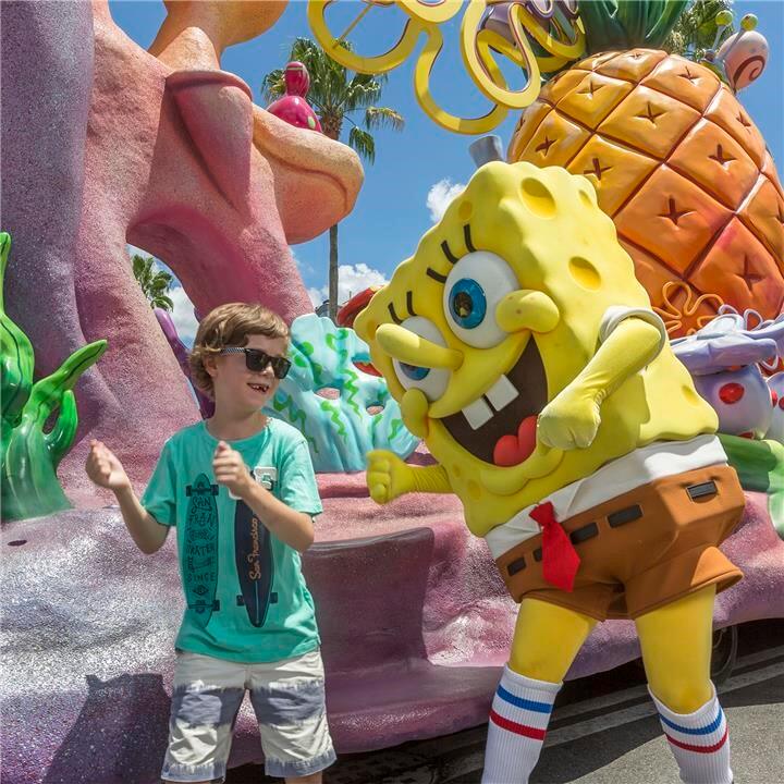 Theme park characters from hit TV shows and movies dance along with the audience at the Hollywood Character Party Zone at Universal Studios Orlando. A young boy dances alongside SpongeBob Squarepants in front of his pineapple house float at Universal Studios Orlando's Hollywood Character Party Zone.