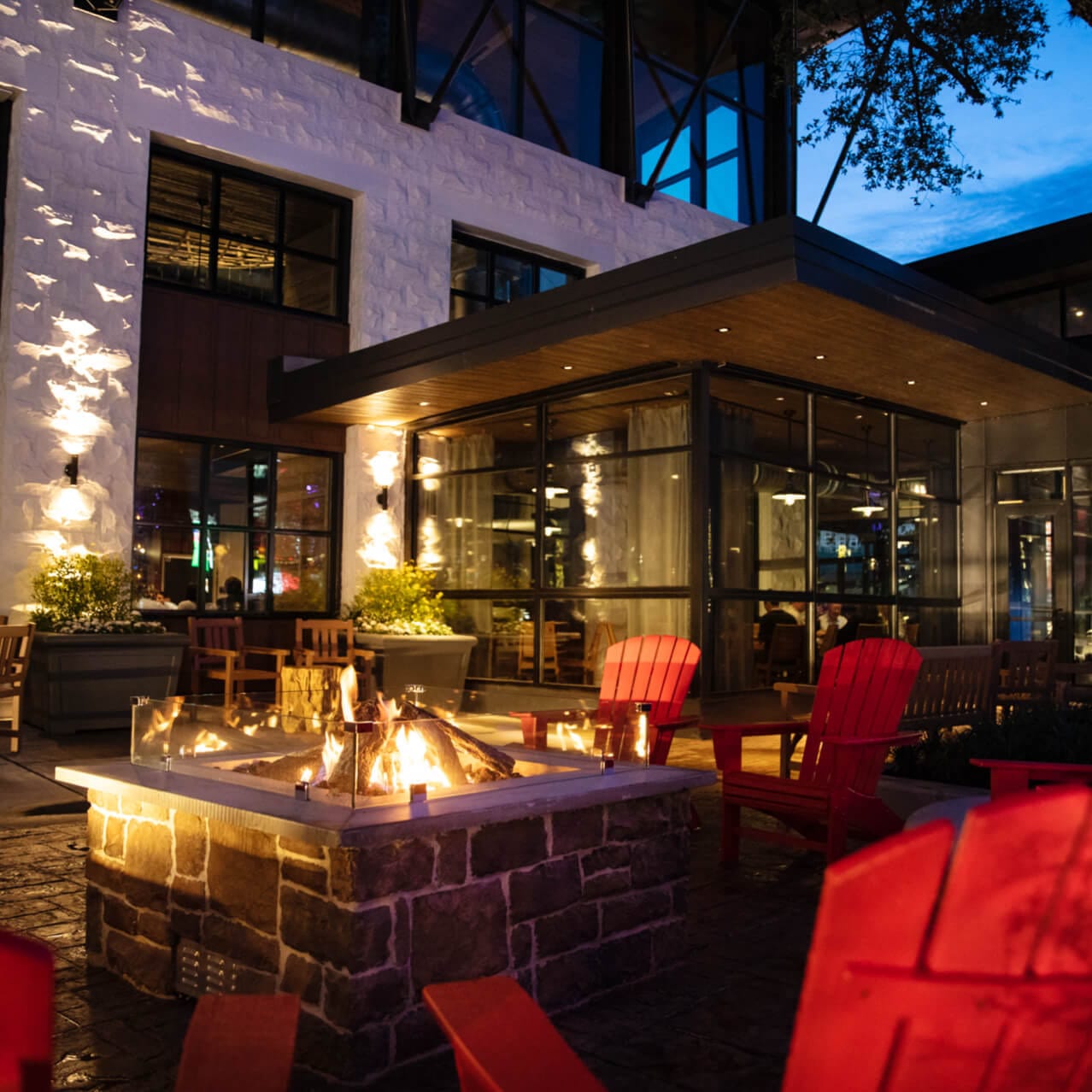 Chairs gathered around a fire pit on the patio at Bigfire.