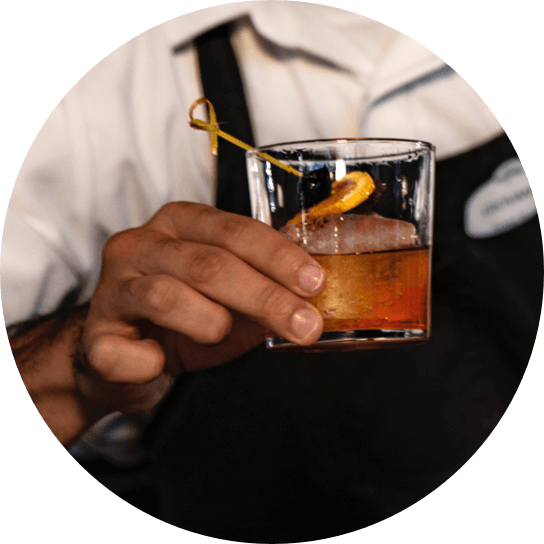 A bartender holds a whiskey drink on the rocks at Bigfire restaurant in Universal CityWalk.