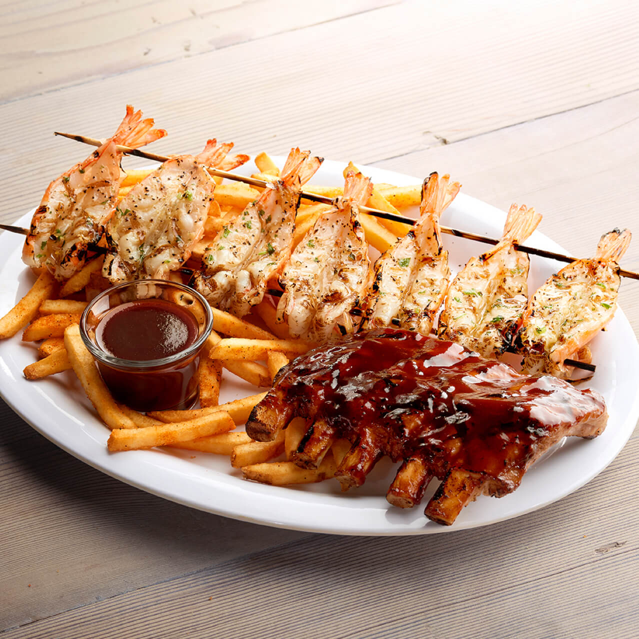 Bubba Gump Shrimp Co.'s LT. DAN’S SURF & TURF plate at CityWalk Orlando, featuring Baby Back Ribs, Grilled Shrimp and Fries.