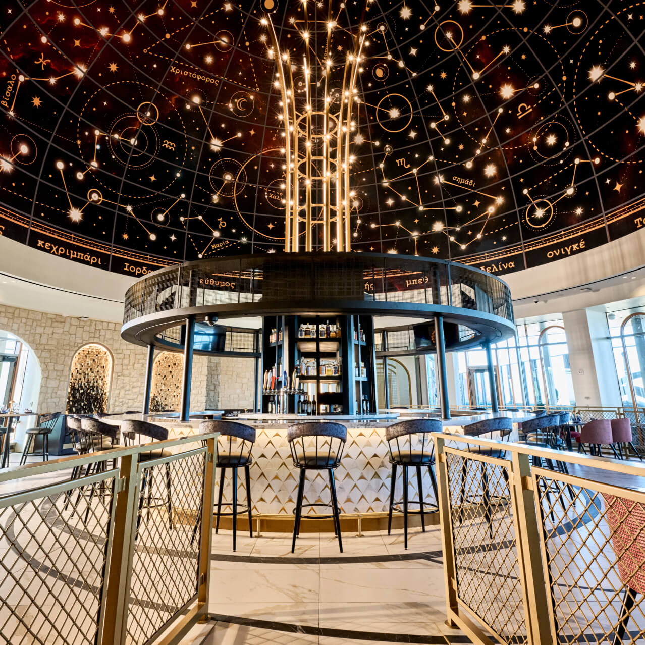 Wide-angle view of the Bar Helios' centre bar, with a dome-shaped constellation focal point on the ceiling.