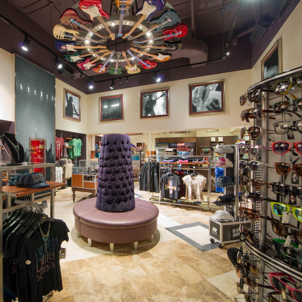 The interior of Rock Shop, a souvenir store at Hard Rock Hotel in Universal Orlando that is decorated with a guitar chandelier and images of music legends.