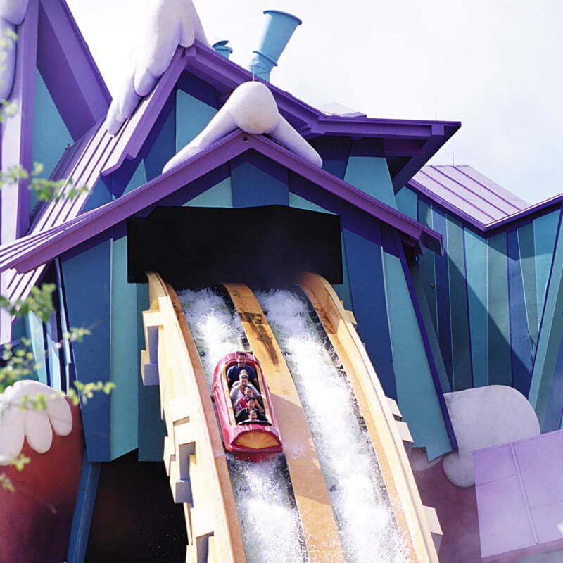 A family flies down the 75-foot drop at the Dudley Do-Right's Ripsaw Falls water ride.
