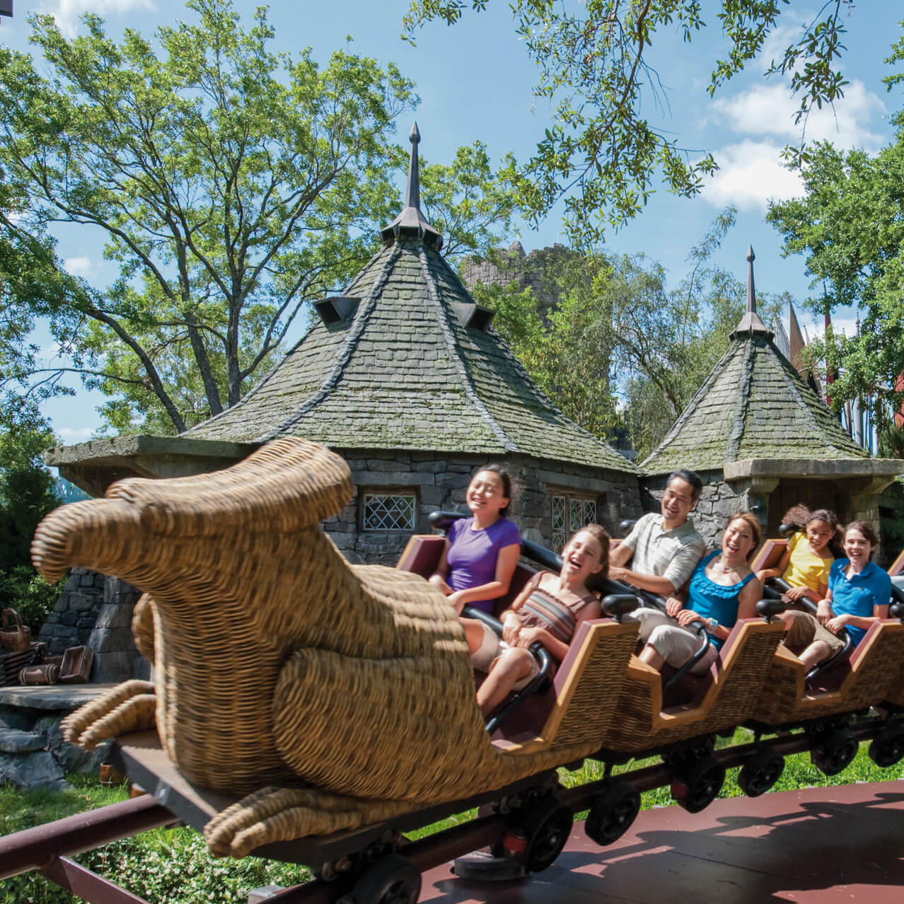 Young theme park guests and their families enjoying the mild roller coaster fun of Flight of the Hippogriff at The Wizarding World of Harry Potter in Universal's Islands of Adventure in Orlando.