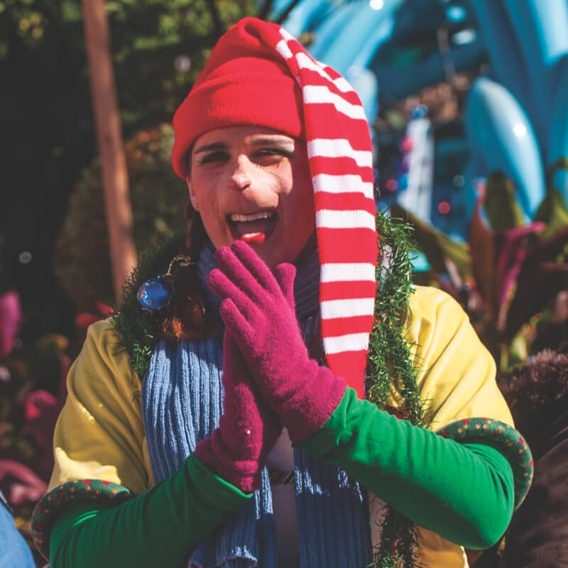 A festive Who claps her hands during Grinchmas at Universal.