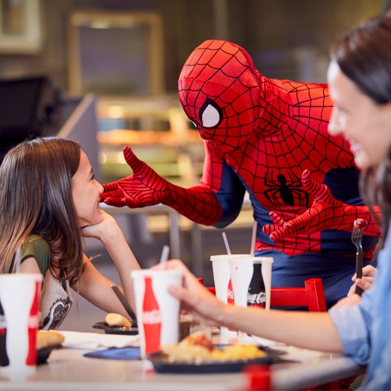 Spider-Man talking to a child in a restaurant
