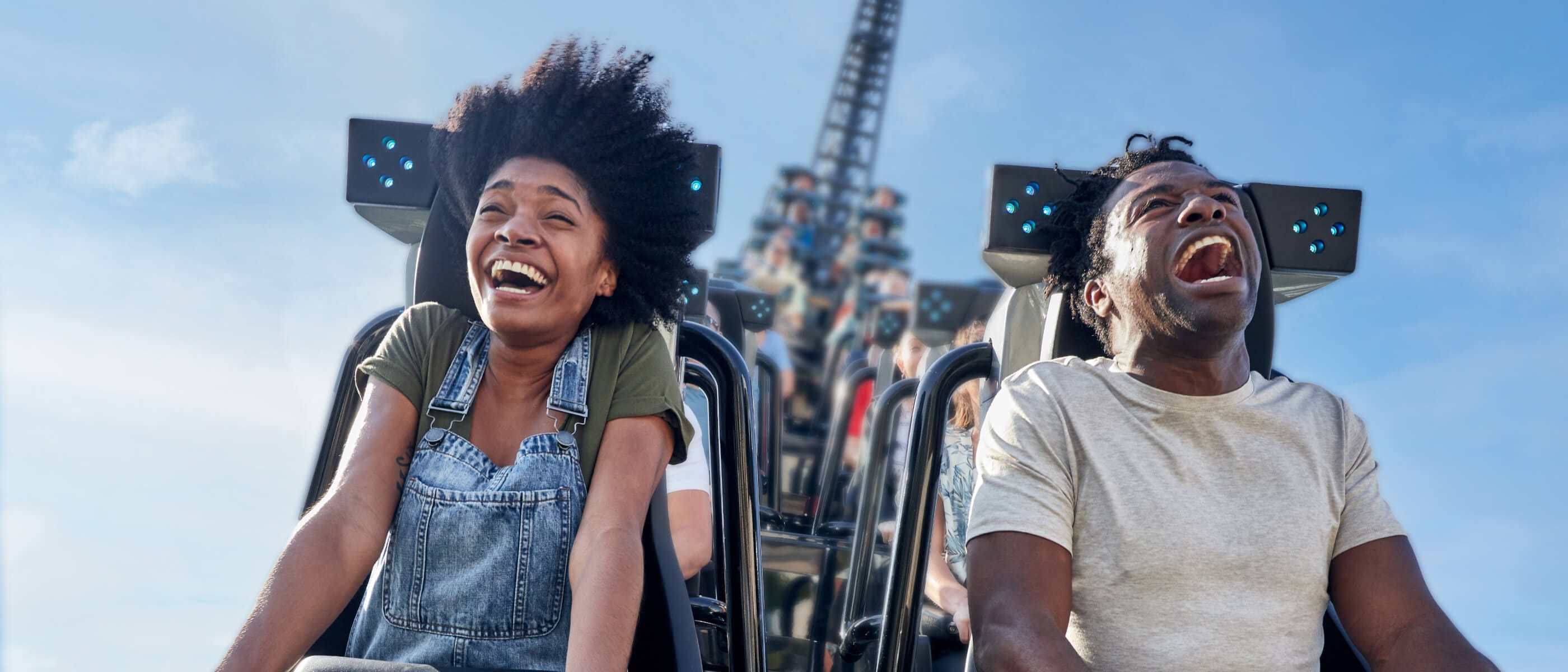 A couple screams in delight while flying high on a rollercoaster at Universal Islands of Adventure.