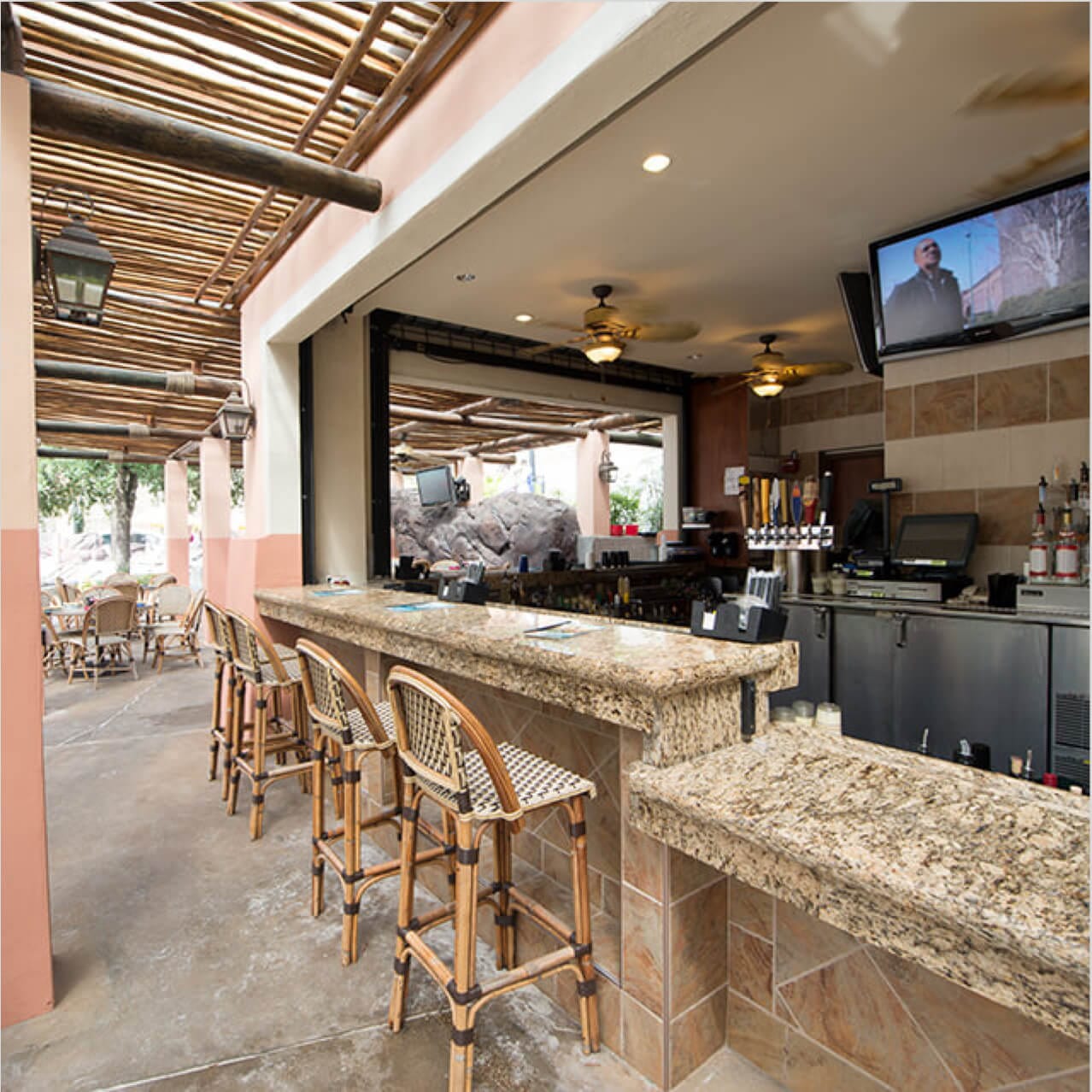 Woven stools at the granite bar of Splendido Bar and Grill inside Loews Portofino Bay Hotel.