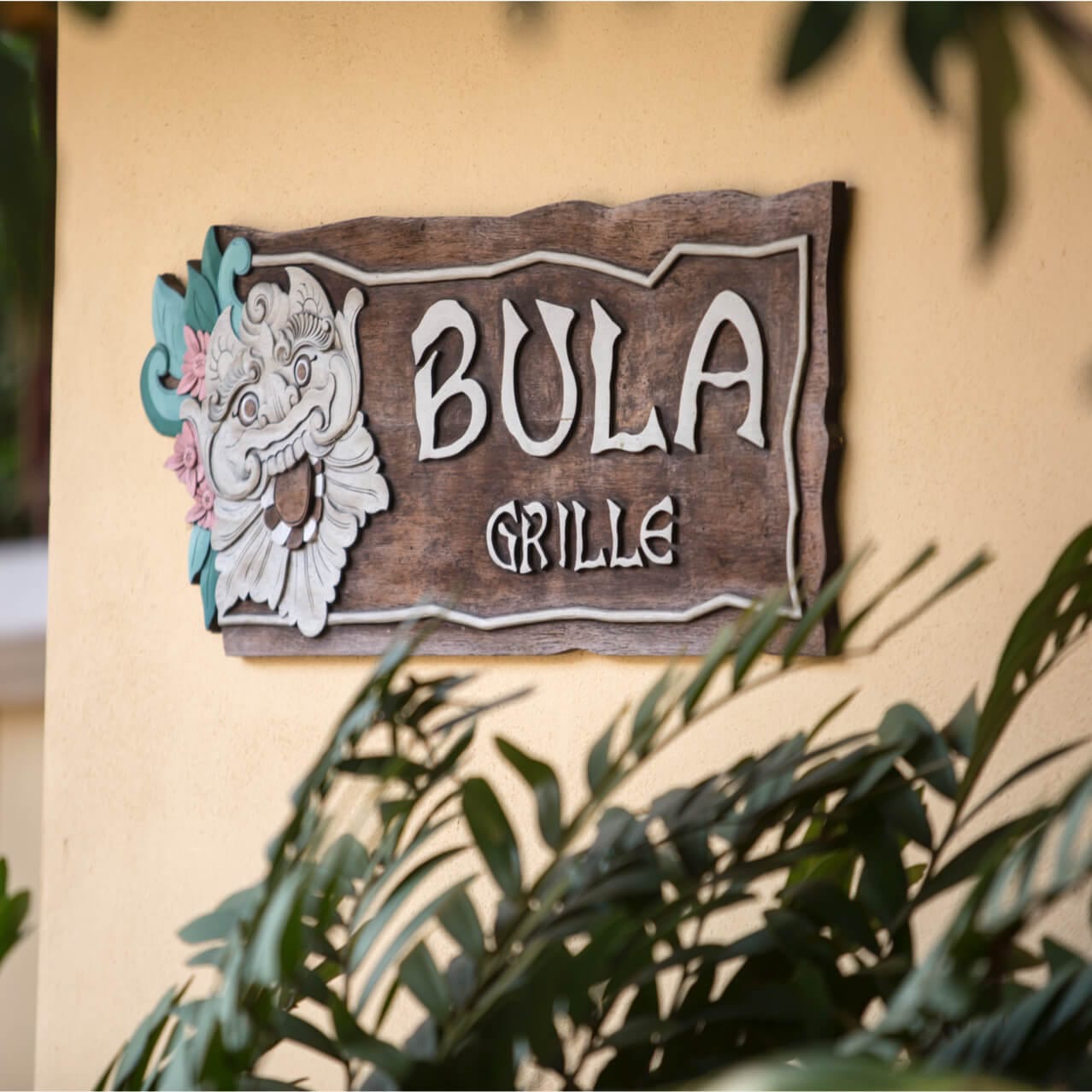 The rustic Bula Grille sign mounted on an outdoor wall at Loews Royal Pacific Resort.