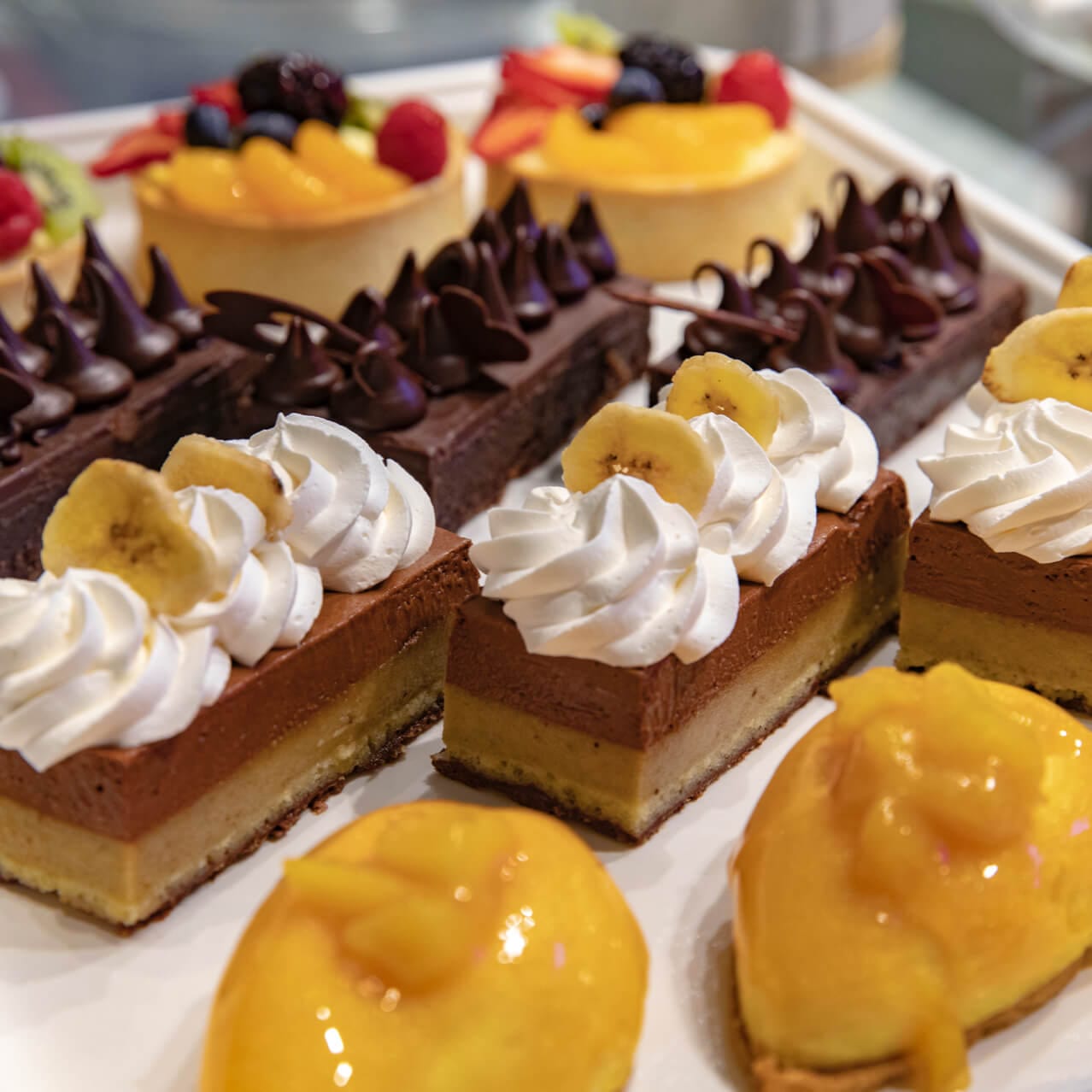 Tray displaying selection of desserts available at Tuk Tuk market.