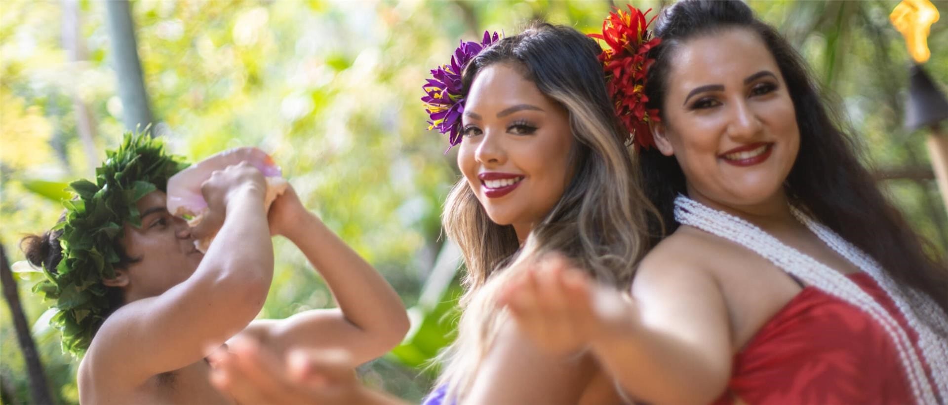 Dancers raise hands to welcome guests during the Wantilan Luau at Loews Royal Pacific Resort in Universal Orlando.