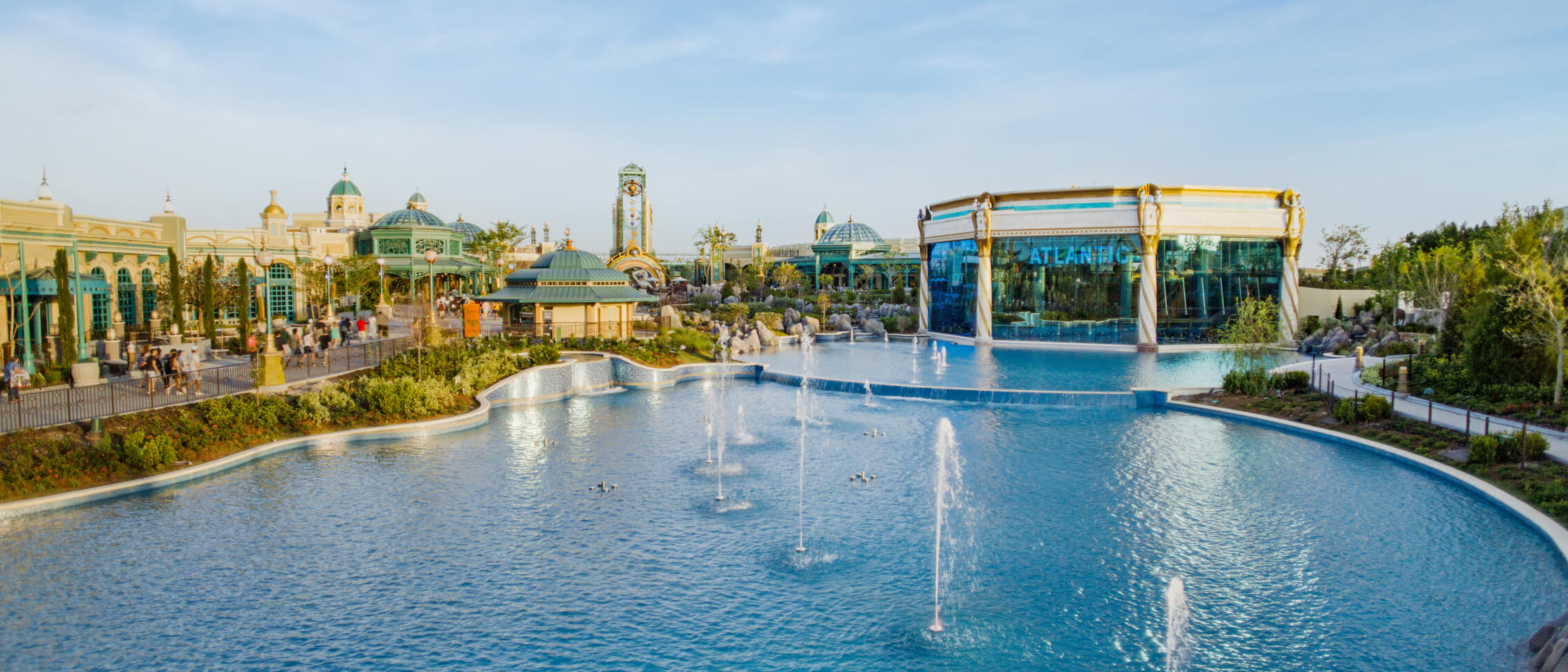 Atlantic sitting across the turquoise waters and water features of Celestial Park, its architecture inspired by Victorian aquariums.