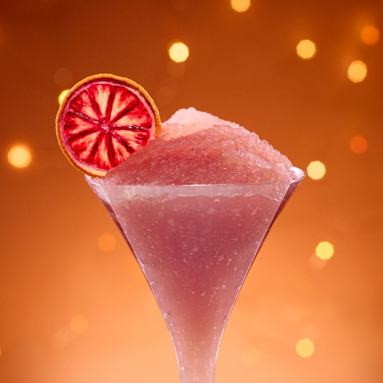 Cosmos-politan, a mix of vodka, limoncello, lime juice, cranberry juice, simple syrup and blood orange syrup, finished with a hint of smoked sea salt and garnished with a dried blood orange wheel, served at Bar Zenith.