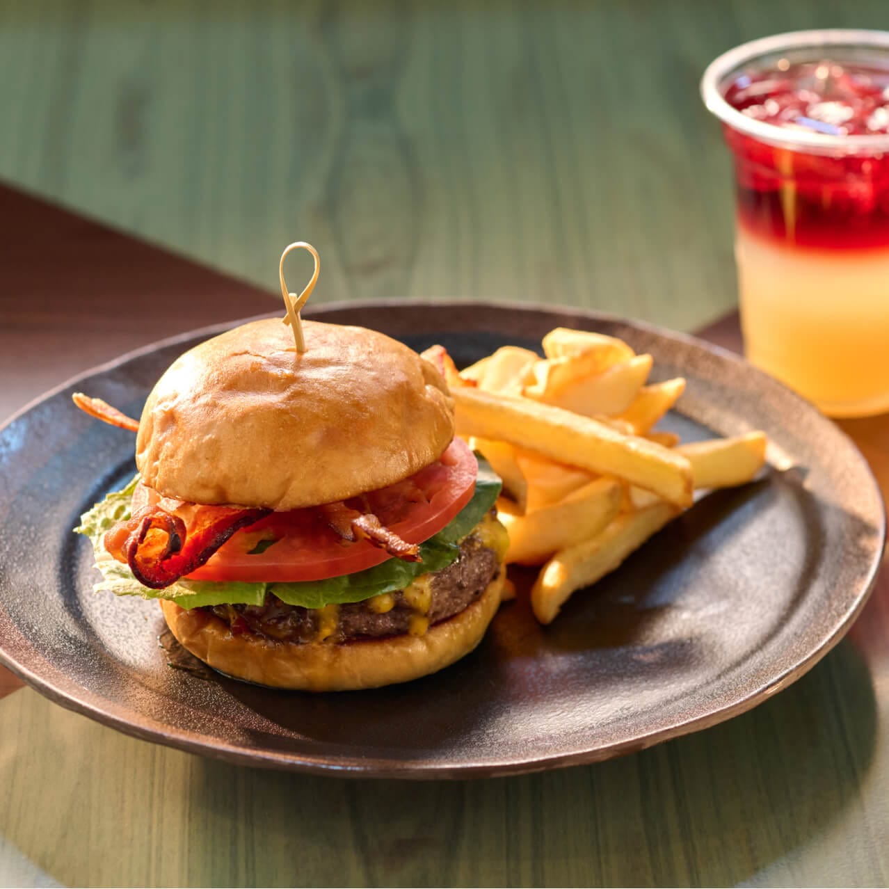 A Bing Bang Burger with black Angus beef, whiskey bacon jam, beer cheese sauce and applewood bacon, served with fries, available at Meteor Astropub.