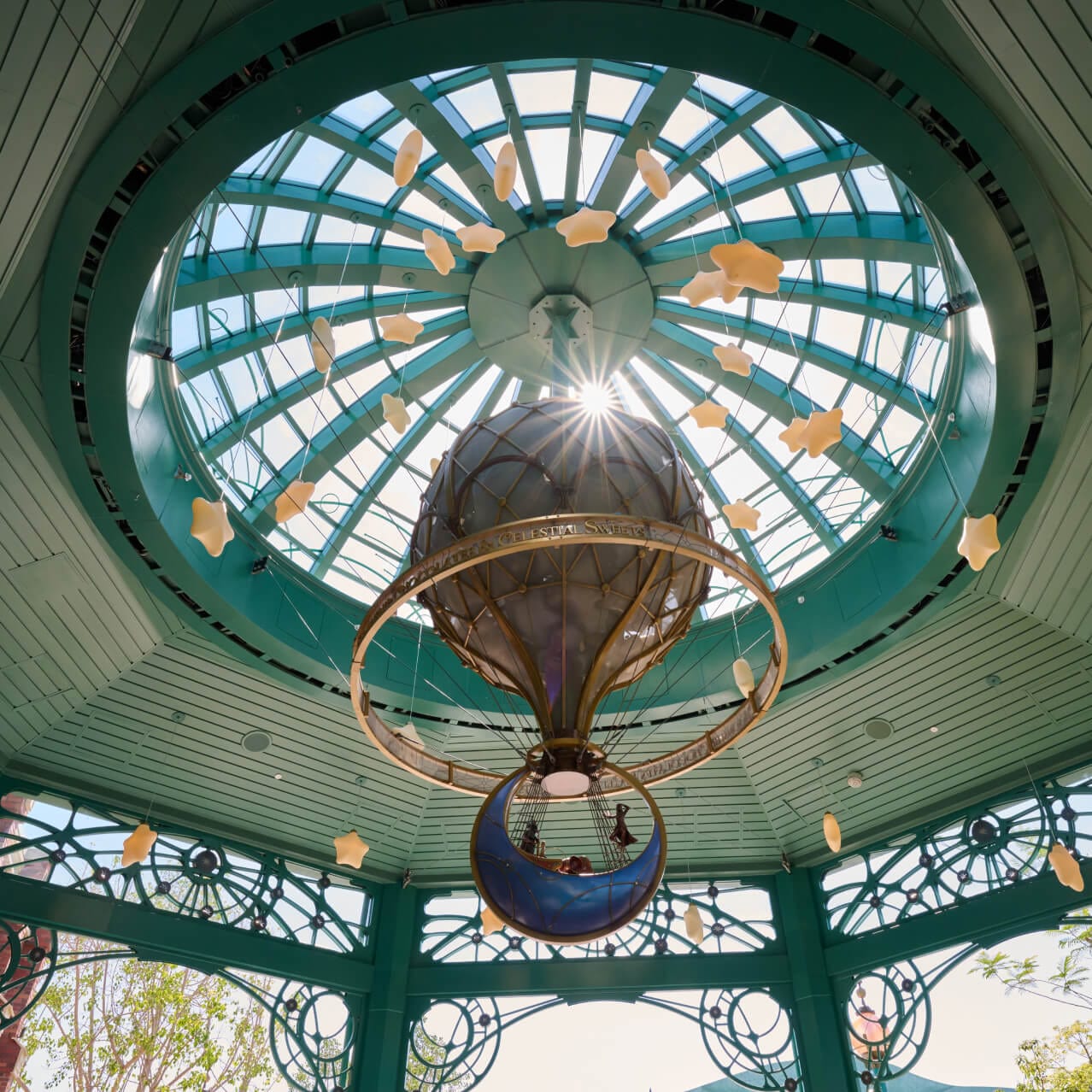 A mini hot air balloon with a moon shaped basket hangs from the ceiling at Moonship Chocolates & Celestial Sweets, in Celestial Park