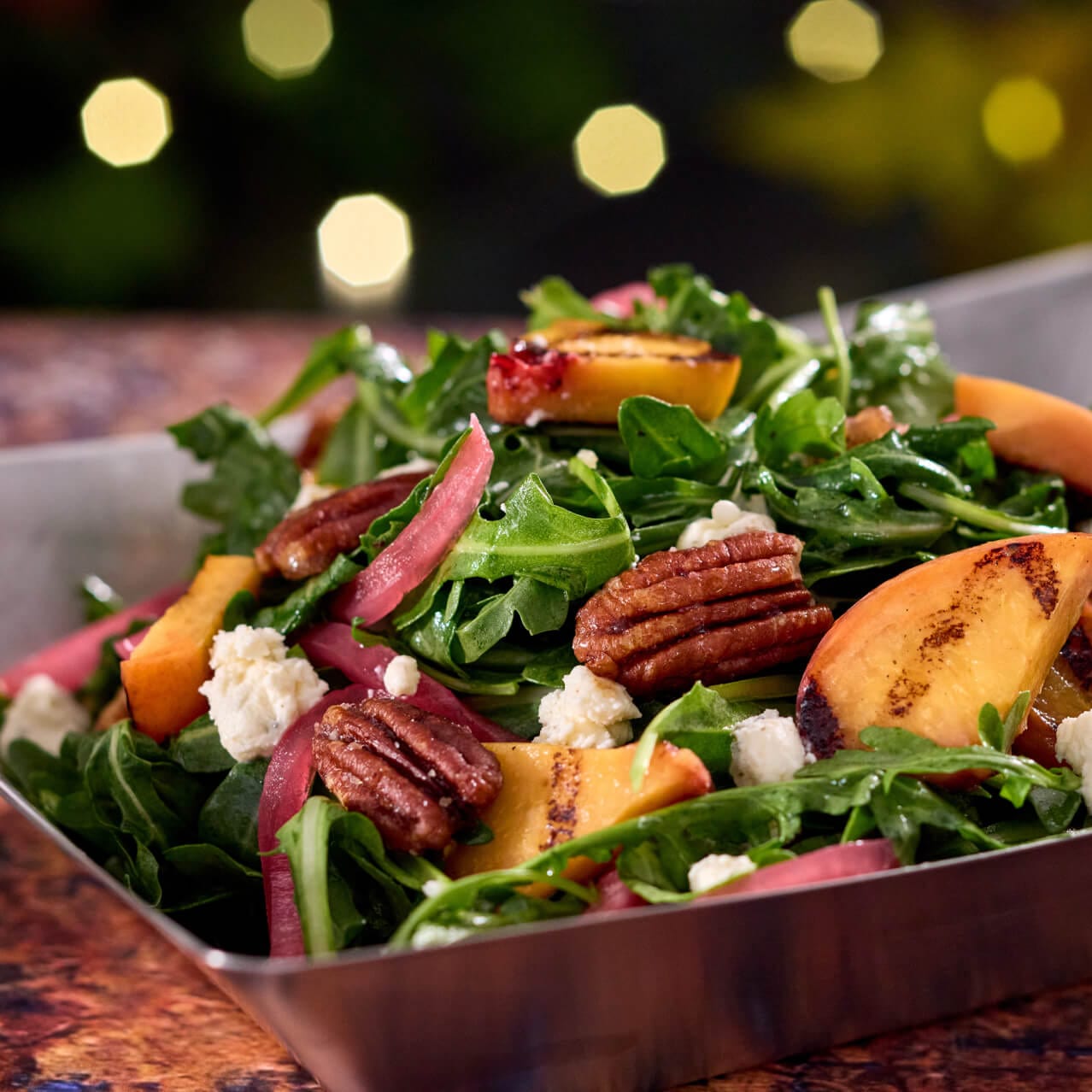 The Grilled Peach Rocket salad at The Oak & Star Tavern in Celestial Park.