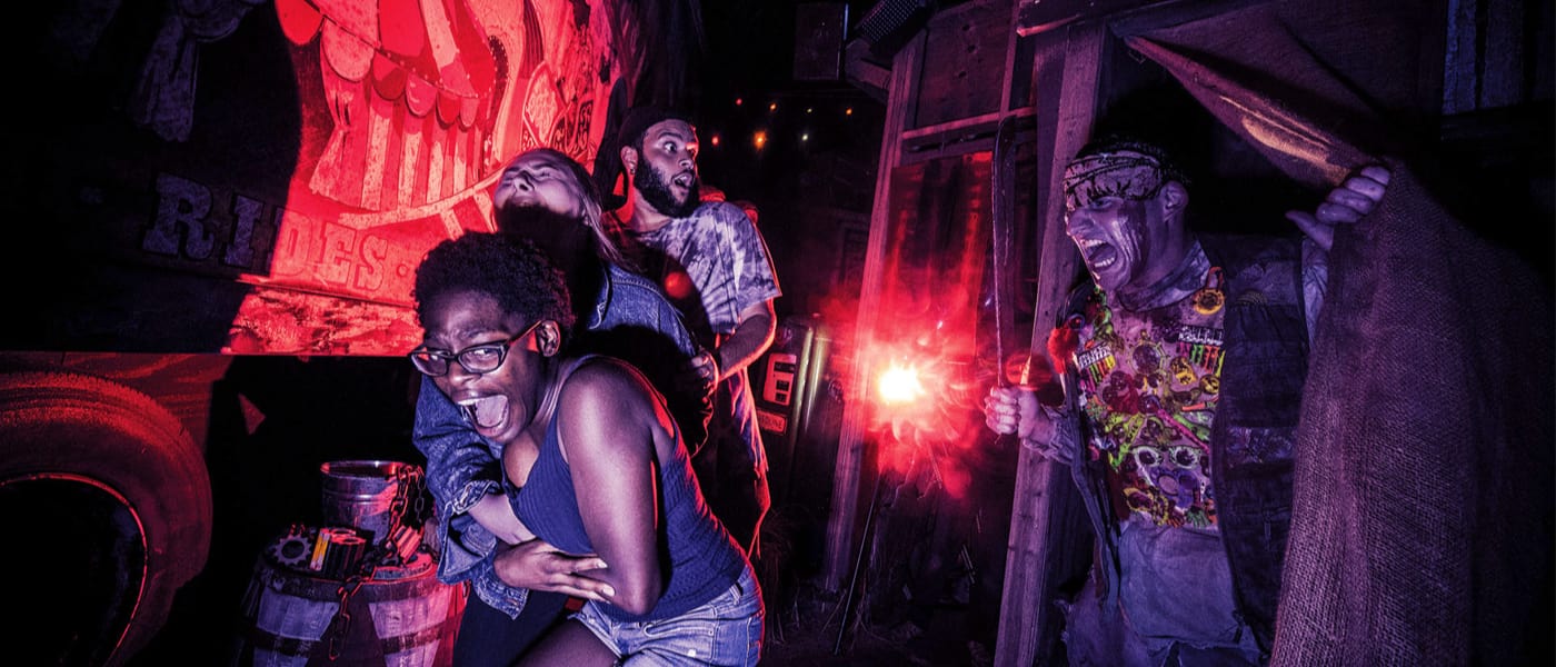 People screaming as they experience Halloween Horror Nights.