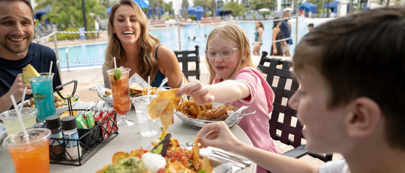 A family of four eats lunch at Beachclub Restaurant at Hard Rock Hotel in Universal Studios Orlando.