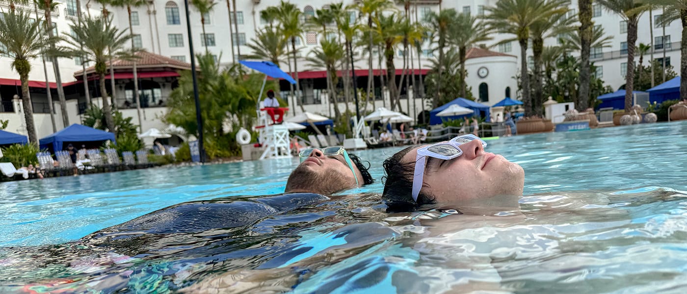 A pair of pals listening to music underwater in the pool at Hard Rock Hotel in Universal Studios Orlando.