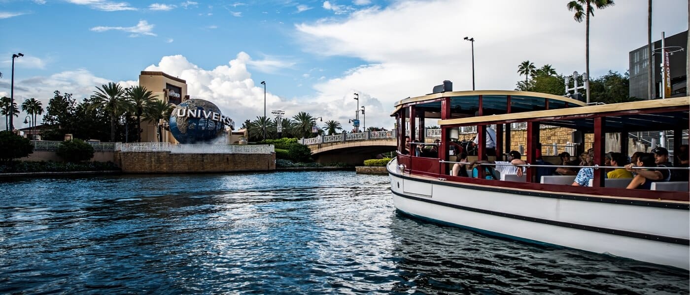 A water taxi cruises towards Loews Sapphire Falls Resort, an on-site hotel at Universal Orlando Resort.