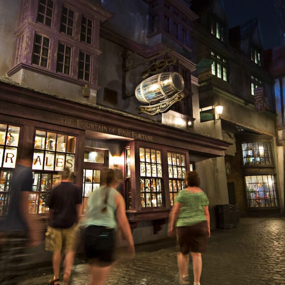 Guests at The Wizarding World of Harry Potter Diagon Alley in Universal Studios Orlando enticed by the entrance to The Fountain of Fair Fortune.