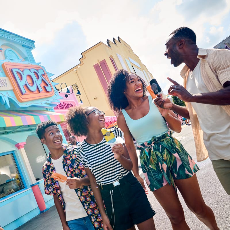 A photo of a family eating frozen treats at Freeze Ray Pops at Universal Studios Florida.
