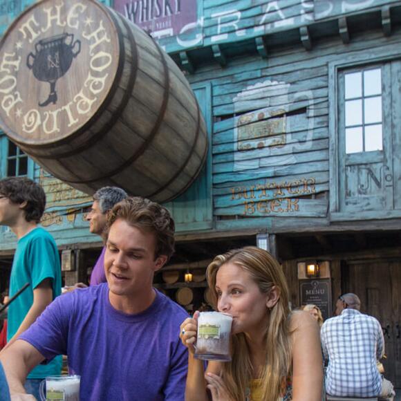 Visitors to the Hopping Pot walk up snack and beverage counter in Diagon Alley at Universal Studios Orlando.