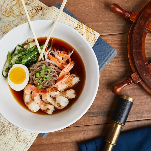 Gulf shrimp, soba noodles, shiitake mushrooms, snow peas, bok choy, pickled vegetables with a soft boiled egg sits on display at Lombard's Seafood Grille, a full service restaurant at Universal Studios Orlando.