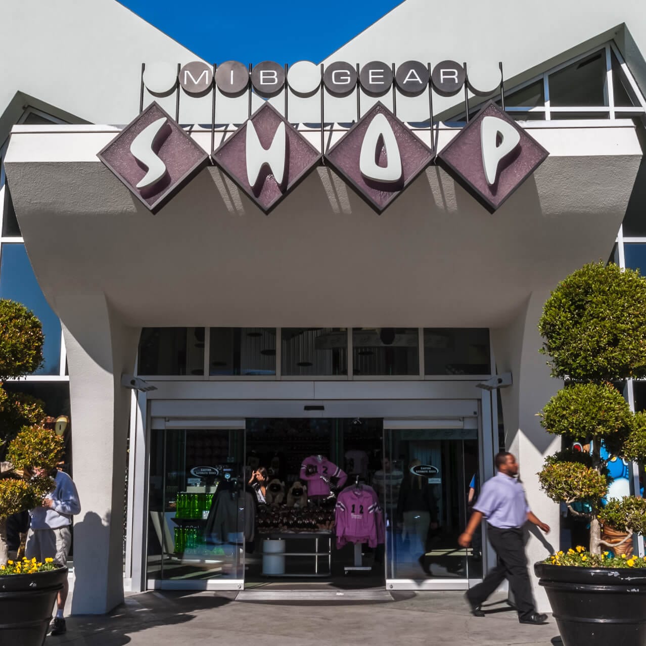 The entrance to MIB Gear Shop at Universal Studios Orlando, featuring a retro-inspired shopfront sign and architecture.