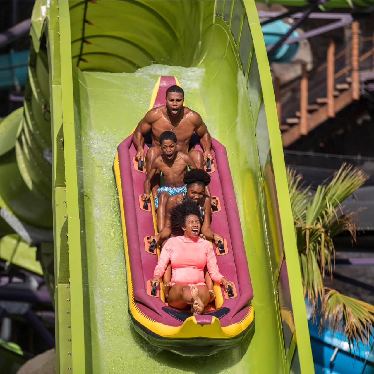 family sliding down the Krakatau Aqua Coaster