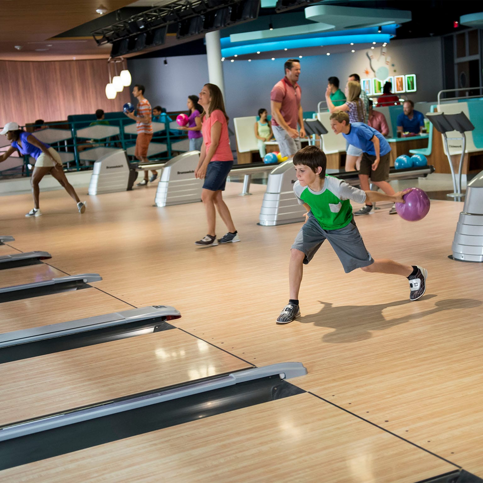 A little boy gets ready to roll a bowling ball at Galaxy Bowl inside Cabana Bay Beach Resort, an on site hotel at Universal Orlando.