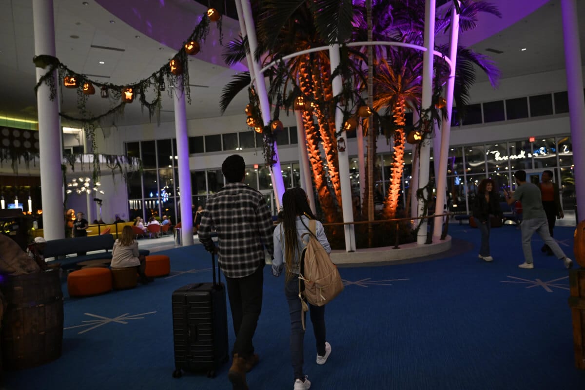Two guests walking through the themed lobby of Universal Cabana Bay Beach Resort during Halloween Horror Nights.
