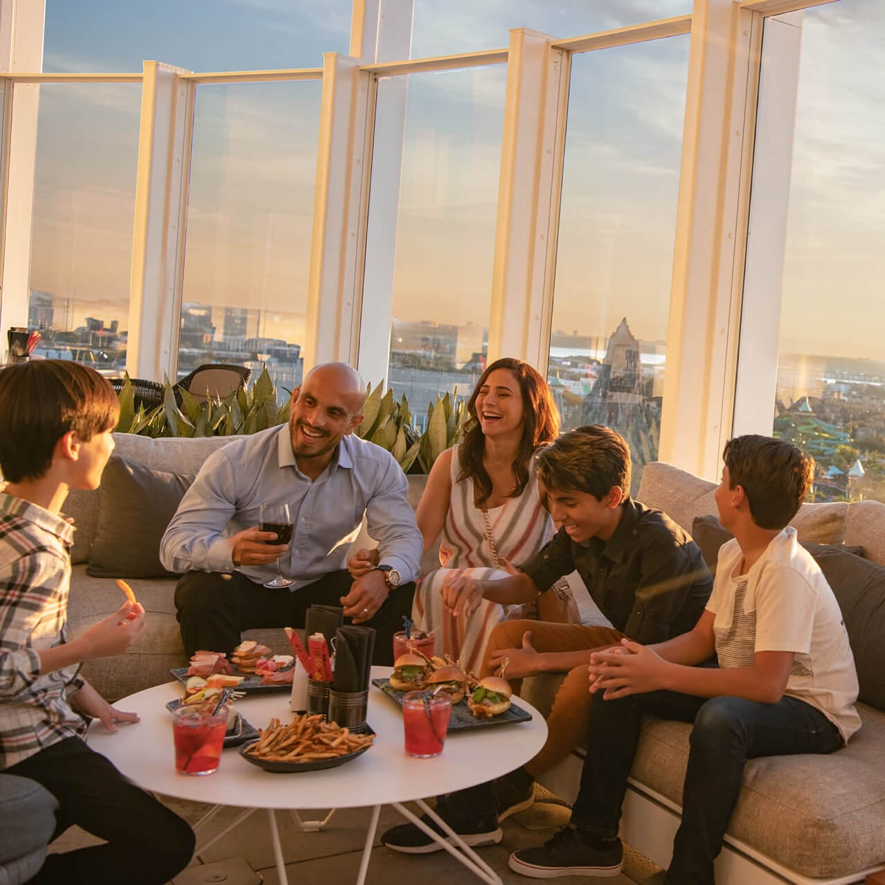 A family dines together overlooking Universal Orlando from the Bar 17 Bistro.